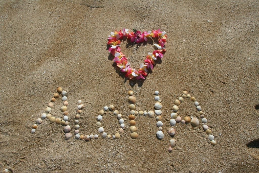 a heart made of beads on sand