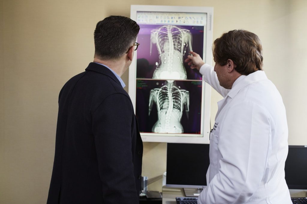 a man looking at a man in a white shirt