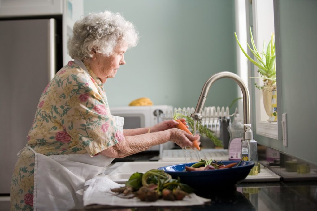 an old woman preparing food