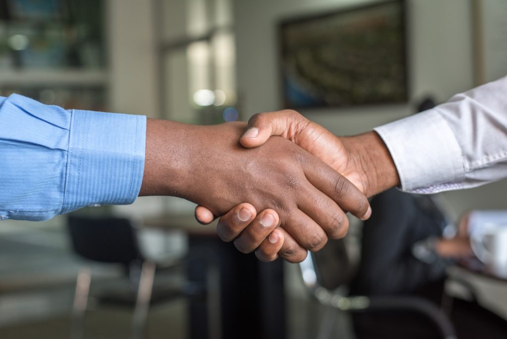 close-up of people shaking hands