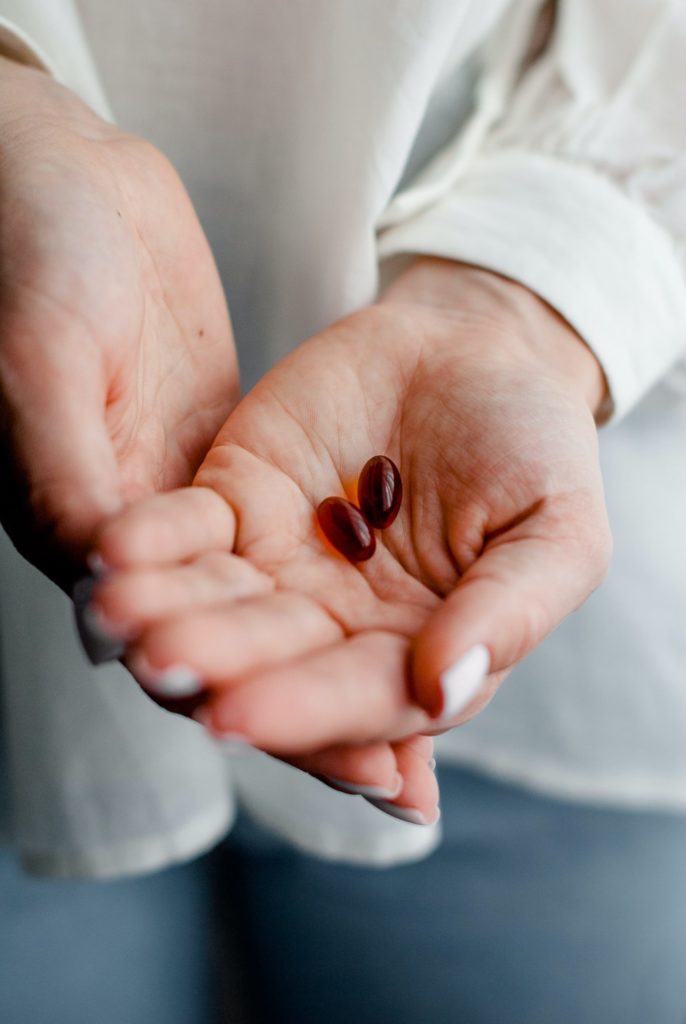 a person's hand holding a baby's feet