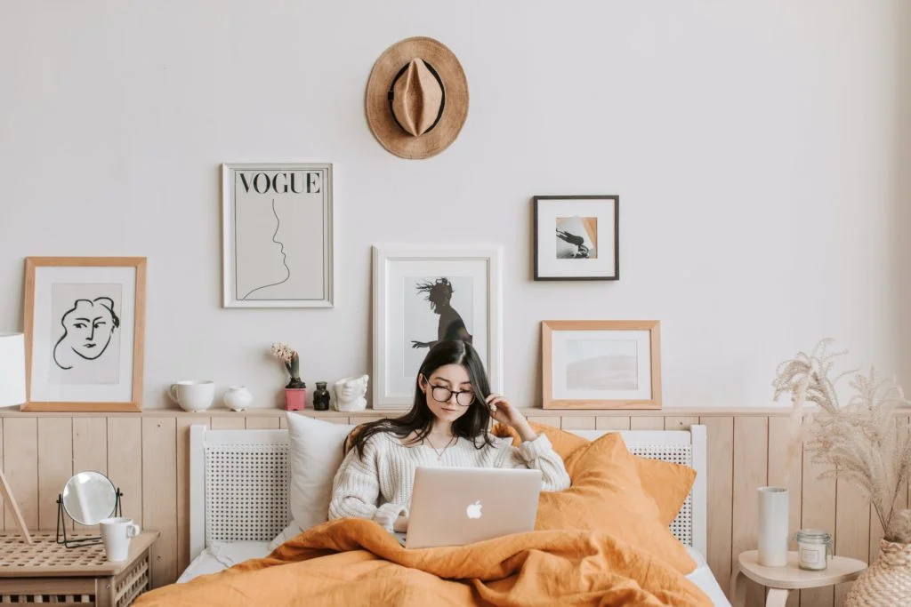 a person sitting on a couch with a laptop