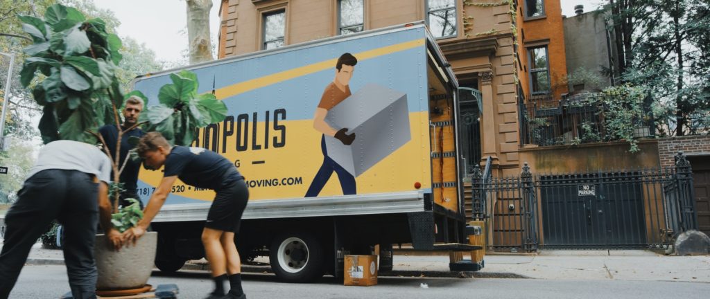 a man carrying a woman on a truck