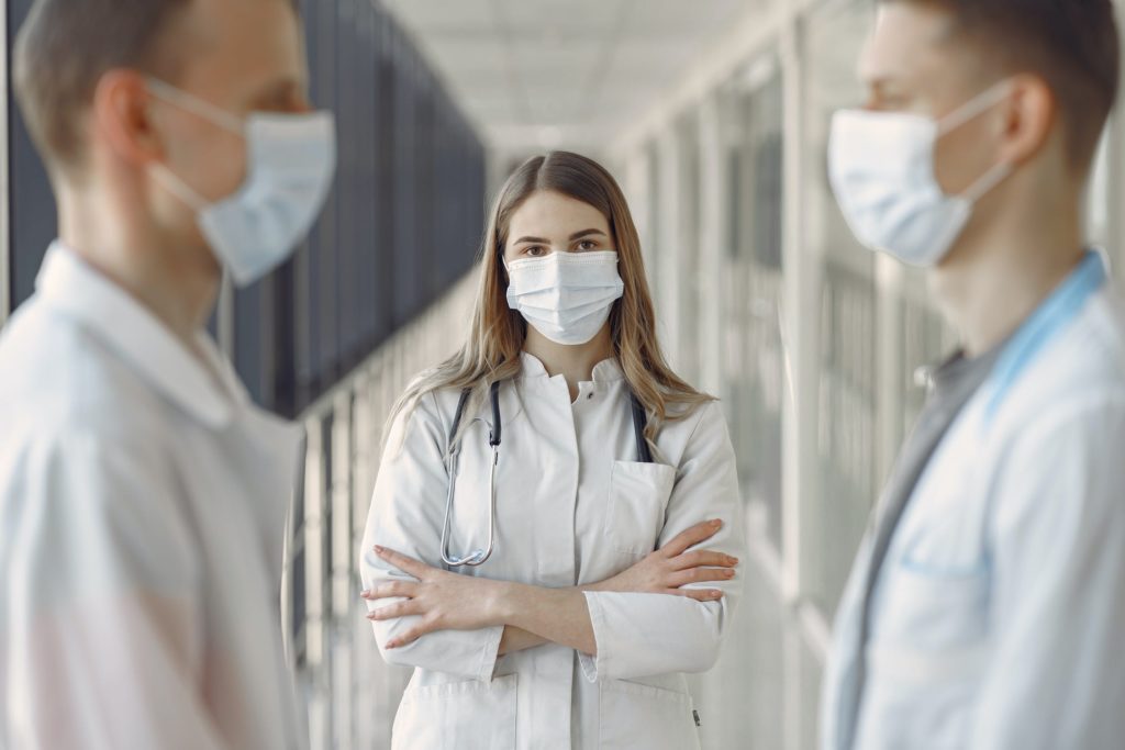 a group of people in white coats