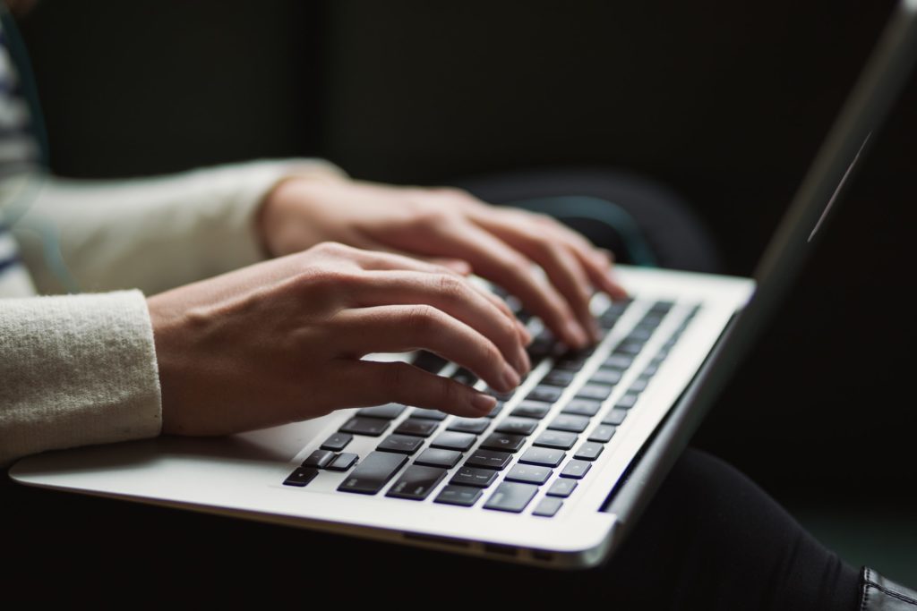 a person typing on a laptop