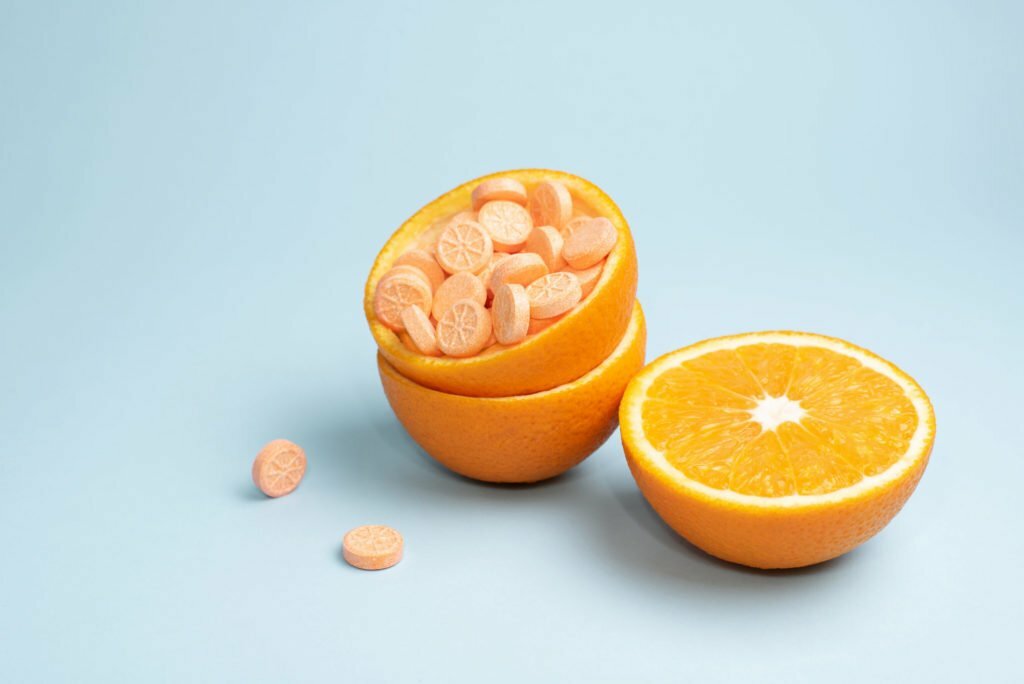 a peeled orange next to an orange
