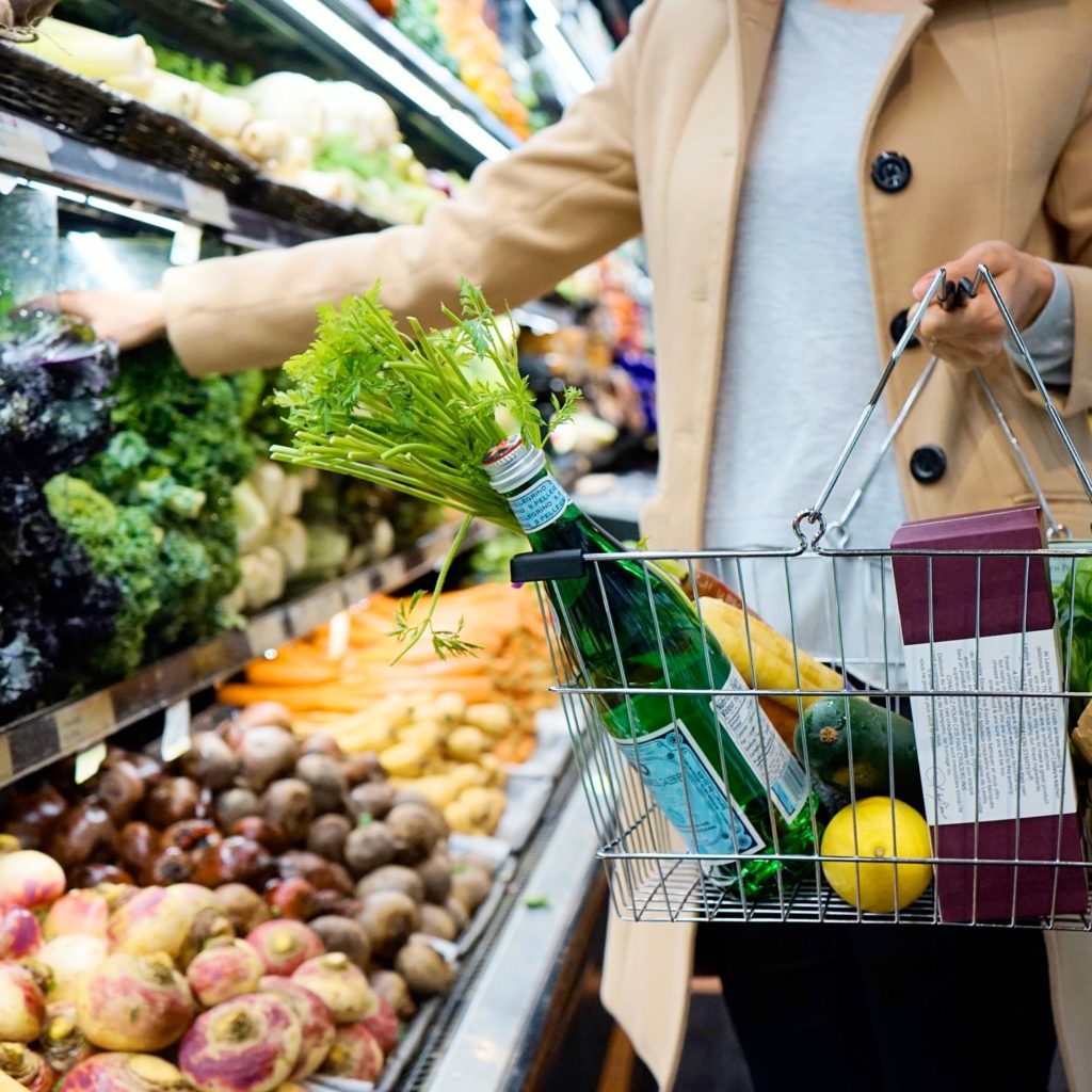 a person holding a bunch of vegetables