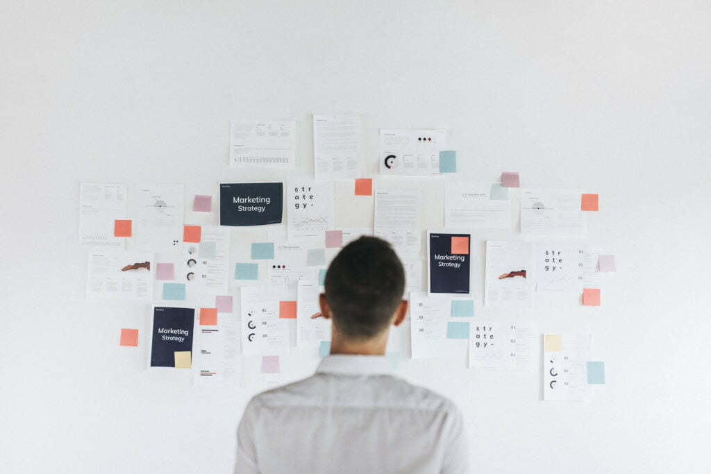 a man looking at a white board