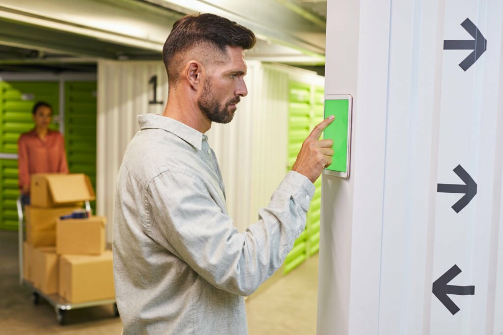 Man Using Control Panel in Self Storage Unit