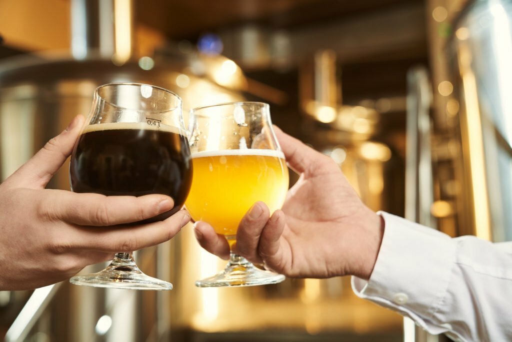 Two glasses of dark and light beer close up